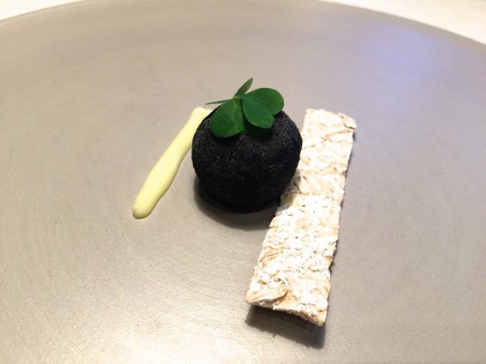 Terra, praline di carré affumicato alla cenere di erbe spontanee, cracker all’avena