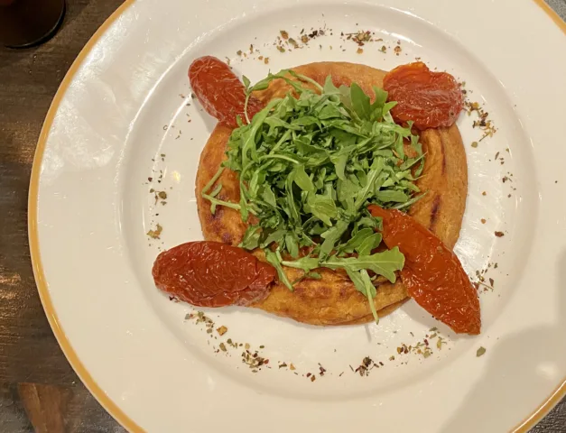 Our-Provoleta-provola-melted-with-arugula-and-dried-tomatoes-
